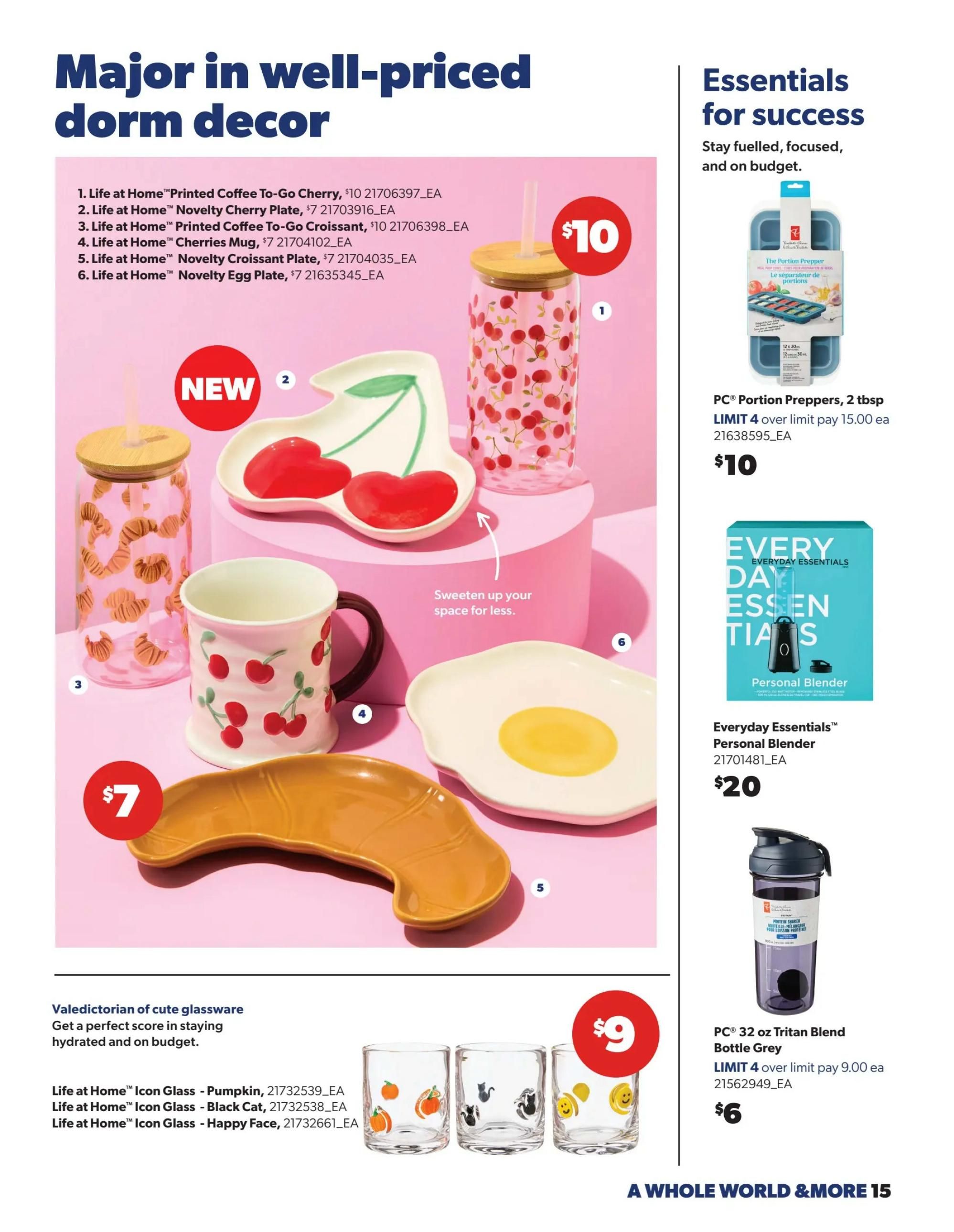 Real Canadian Superstore flyer page 15 featuring 'Major in well-priced dorm decor' and 'Essentials for success'. The decor section showcases Life at Home items including a Printed Coffee To-Go Cherry cup for $10, a Novelty Cherry Plate for $7, a Printed Coffee To-Go Croissant cup for $10, a Cherries Mug for $7, a Novelty Croissant Plate for $7, and a Novelty Egg Plate for $7. Also featured are Life at Home Icon Glasses in Pumpkin, Black Cat, and Happy Face designs for $9. On the right side, under 'Essentials for success', find PC Portion Preppers, 2 tbsp, for $10 with a limit of 4, and an Everyday Essentials Personal Blender for $20. Additionally, a PC 32 oz Tritan Blend Bottle in Grey is available for $6 with a limit of 4.